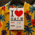 Red I Love Sale Was and Now Hanger Ticket Punched on Summer Shirt – Clothing Discount Label Display