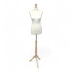 Cream female tailors dummy size 10/12 with maple wooden tripod stand and neck cap, ideal for dressmaking and display.
